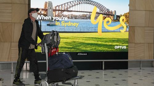 Passengers arrive early morning at Sydney Airport amid the new rules.