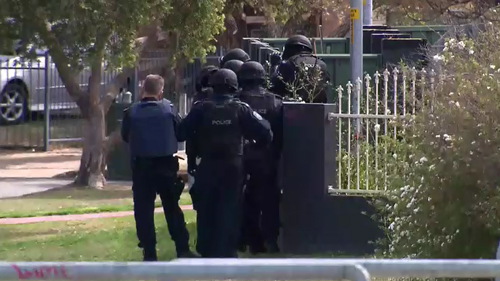 Armed officers stormed the property where the dog is believed to have been in the yard.