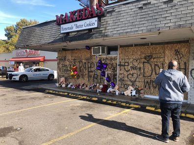 A memorial to murdered rapper Young Dolph sits in front of windows lined with Makeda's Cookies on Thursday, November 18, 2021