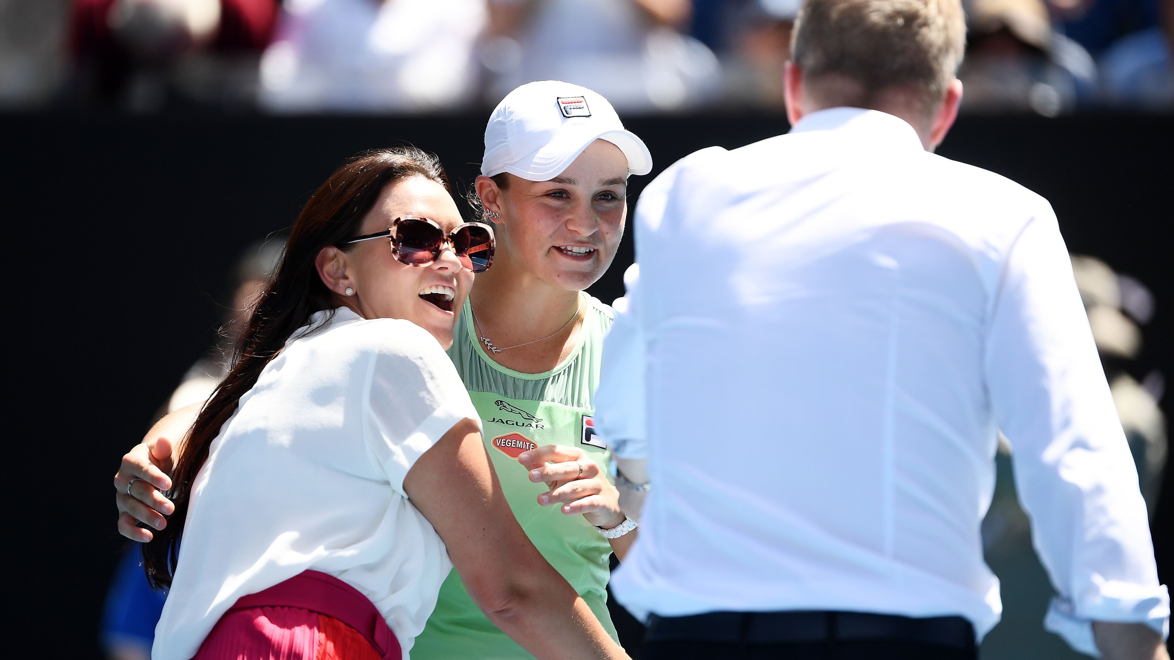 Ashleigh Barty with Casey Dellacqua as Jim Courier stands to the side.
