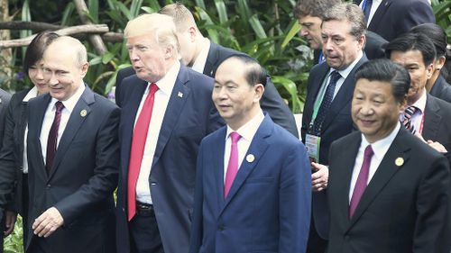 Russia's President Vladimir Putin, U.S. President Donald Trump, Vietnam's President Tran Dai Quang and China's President Xi Jinping heads for a photo session. (AAP)
