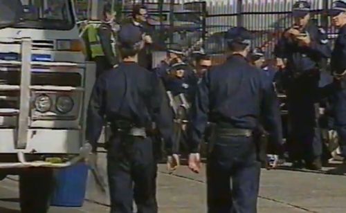 Police officers lay flowers after the death of the two officers. Picture: 9NEWS