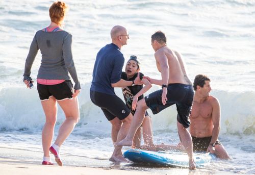 The lifeguards dragged the woman to safety out of the water.