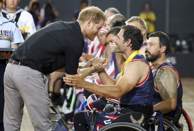 Britain's Prince Harry congratulates a member of the United States wheelchair basketball team after winning the gold medal in the finals during day eight of the Invictus Games Sydney, Australia, Saturday, Oct. 27, 2018. 