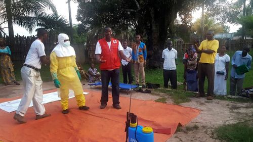 Members of a Red Cross team don protective clothing before heading out to look for suspected victims of Ebola, in Mbandaka. Picture: AP