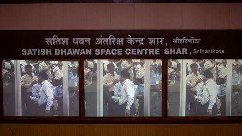 Screens show Indian Space Research Organisations (ISRO) chairman S. Somanath being congratulated by colleagues after the successful launch of the mission.