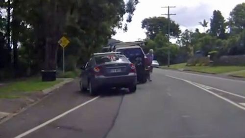 The men get out of their vehicles ahead of their brawl. (Dash Cam Owners Australia)