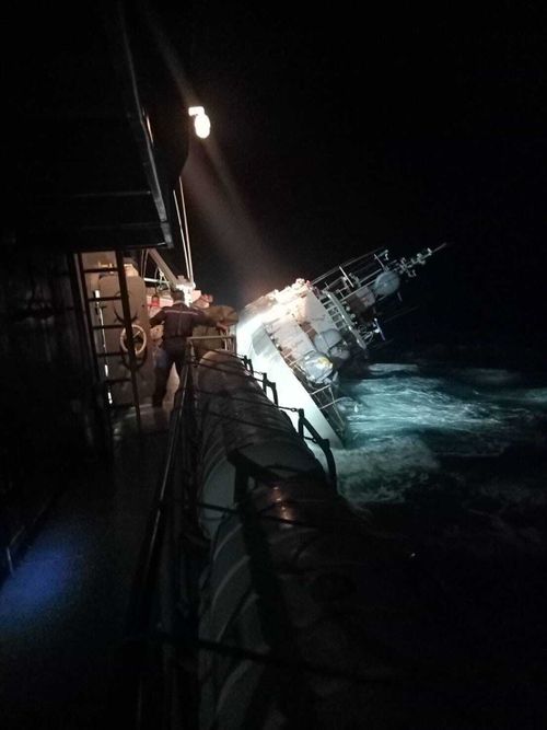 the HTMS Sukhothai corvette leans on its side off the coast of Prachuap Khiri Khan province.