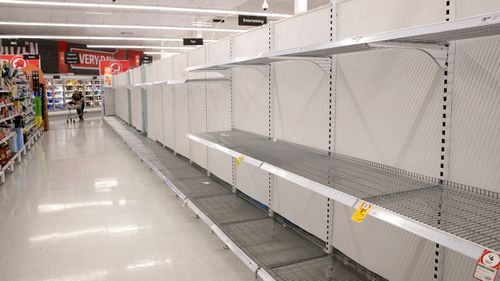Empty toilet paper shelves in a Coles store in Sydney. Some customers have stockpiled toilet rolls and other essential items.