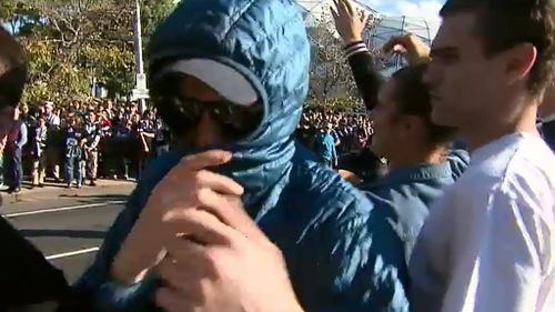 The minority of football fans covering their face cast a negative image on the majority who are well-behaved. (9NEWS)