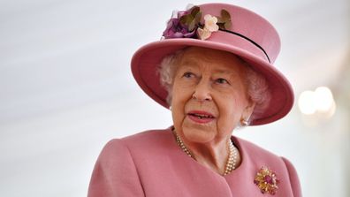 Britain's Queen Elizabeth II speaks with staff during a visit to the Defence Science and Technology Laboratory (Dstl) at Porton Down science park on October 15, 2020 near Salisbury, England.