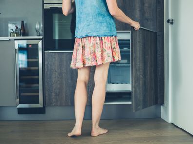 Woman opening freezer