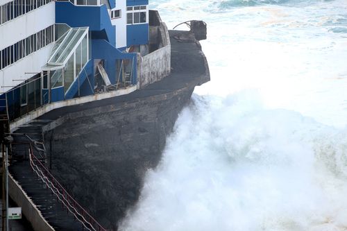 The waves crashed over the sea wall and into the apartment block.