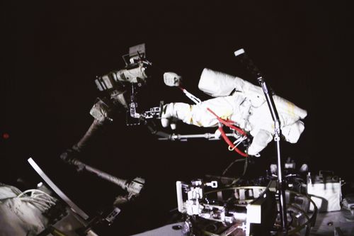 Chinese astronaut Cai Xuzhe conducting extravehicular activities, also known as a spacewalk.