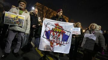 A man holds a banner that shows a map of Kosovo and Serbian coat of arms and flag reading: &#x27;&#x27;No surrender!&#x27;&#x27; during a protest against the Serbian authorities and French-German plan for the resolution of Kosovo, in Belgrade, Serbia, Wednesday, Feb. 15, 2023. Hundreds of pro-Russia nationalists have rallied outside the Serbian presidency building demanding that President Aleksandar Vucic reject a Western plan for normalization of ties with breakaway Kosovo and pull out of negotiations. Shouting Tr