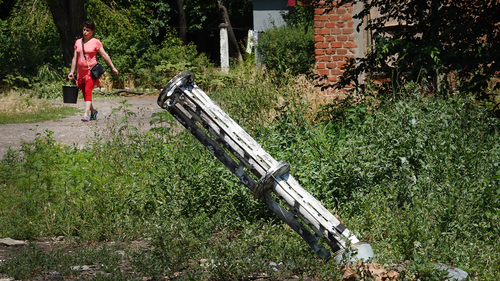 The remains of a missile that dropped cluster bombs in a residential housing complex is lodged in the ground near the complex on June 27, 2022 in Sloviansk, Ukraine. 