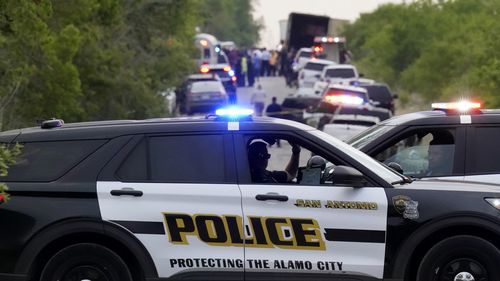 Police block the scene where a semitrailer with multiple dead bodies was discovered in San Antonio.