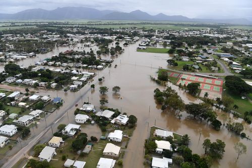 Houses are inundated with flood waters in Ingham in North Queensland, Sunday. (AAP)