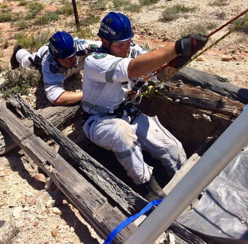 Police rescuers used a pulley and harness to bring the woman back to the surface. (Supplied)