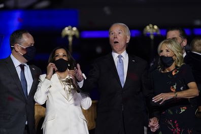 From left, Doug Emhoff, husband of Vice President-elect Kamala Harris, Harris, President-elect Joe Biden and his wife Jill Biden react after confetti was released Saturday, Nov. 7, 2020, in Wilmington, Del. (AP Photo/Andrew Harnik)