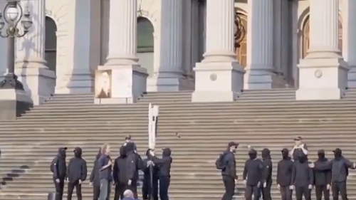 Police are seeking to identify a group of neo-Nazis who posed for a photo and chanted on the steps of Victoria's Parliament House. ﻿