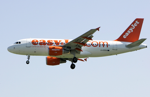 In this file photo dated Wednesday, April 23, 2008, an EasyJet jetliner lands at the Milan Linate airport, Italy. European budget airline eastJet said Thursday May 28, 2020, it plans to cut up to a third of its 15,000-strong workforce as the global aviation industry struggles to cope with the COVID-19 pandemic