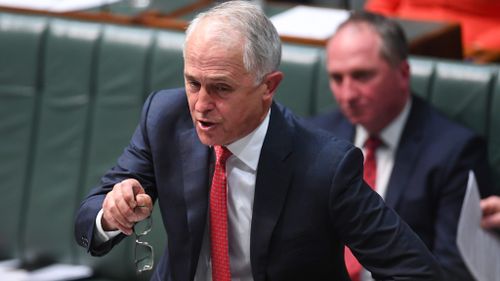 Prime Minister Malcolm Turnbull gives a fiery address during Question Time, with newly-returned New England MP Barnaby Joyce sitting behind him (AAP)