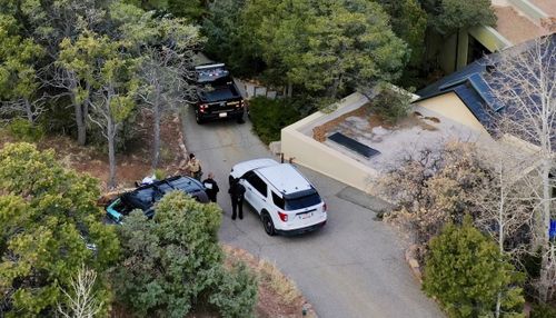 Law enforcement officials talk outside the home of actor Gene Hackman on Thursday, Feb. 27, 2025 in Santa Fe, New Mexico 