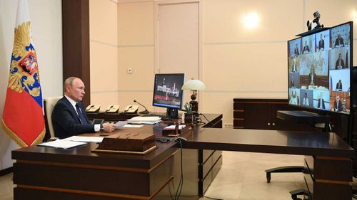 Vladimir Putin holds a video conference ahead of a national address.