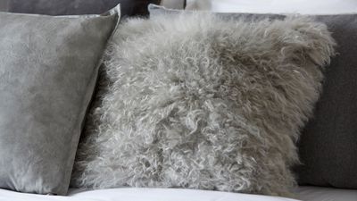 Choosing different fabrics and grey tones in styling the bed.