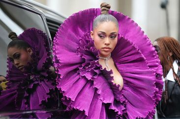 PARIS, FRANCE - JANUARY 25: Jordyn Woods wears earrings, a gown with purple gathered pleated oversized collar, outside Robert Wun, during the Haute Couture Spring/Summer 2024 as part of  Paris Fashion Week on January 25, 2024 in Paris, France. (Photo by Edward Berthelot/Getty Images)