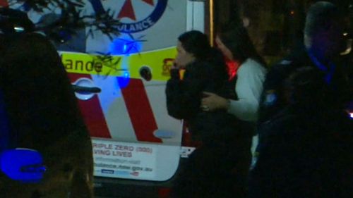 A visibly distressed woman, believed to be the child's mother, at the home last night. (9NEWS)