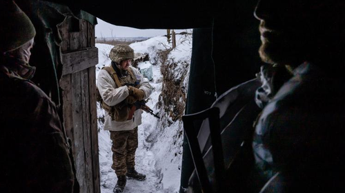 Ukrainian soldiers in a front line trench position in Donbas take shelter from the extreme cold.
