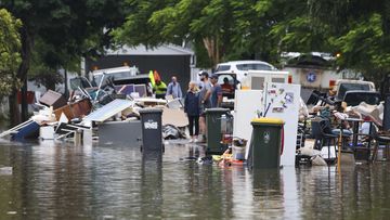 Rubbish is placed at a flooded Vincent Street, Auchenflower  in Brisbane.