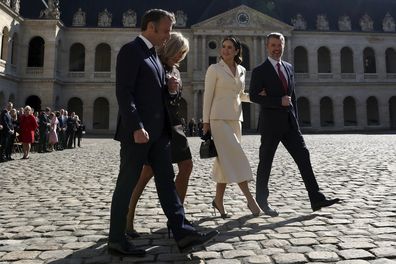 French President Emmanuel Macron and his wife Brigitte Macron, left, walk with Denmark's Queen Mary and Denmark's King Frederik X during an official welcome ceremony in the courtyard of the Invalides monument, in Paris, Monday, March 31, 2025.(Gonzalo Fuentes/Pool via AP)
