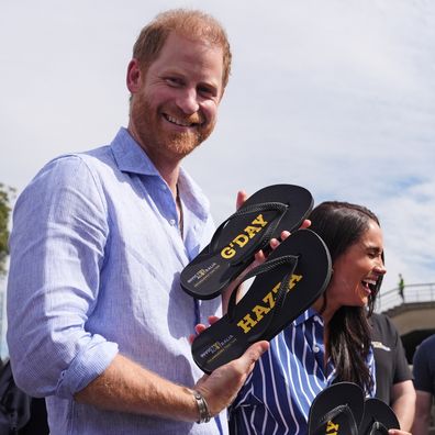 Prince Harry, Duke of Sussex and Meghan, Duchess of Sussex receive flip-flops with the inscriptions "G'day Hazza" and "G'day Megs" at a sailing event with members of Invictus Australia in Sydney Harbour, on day four of the royal trip on April 17, 2026 in Sydney, Australia. 