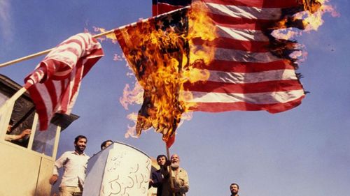 Revolutionary Iranian students storming the US embassy in November 1979. (Getty)