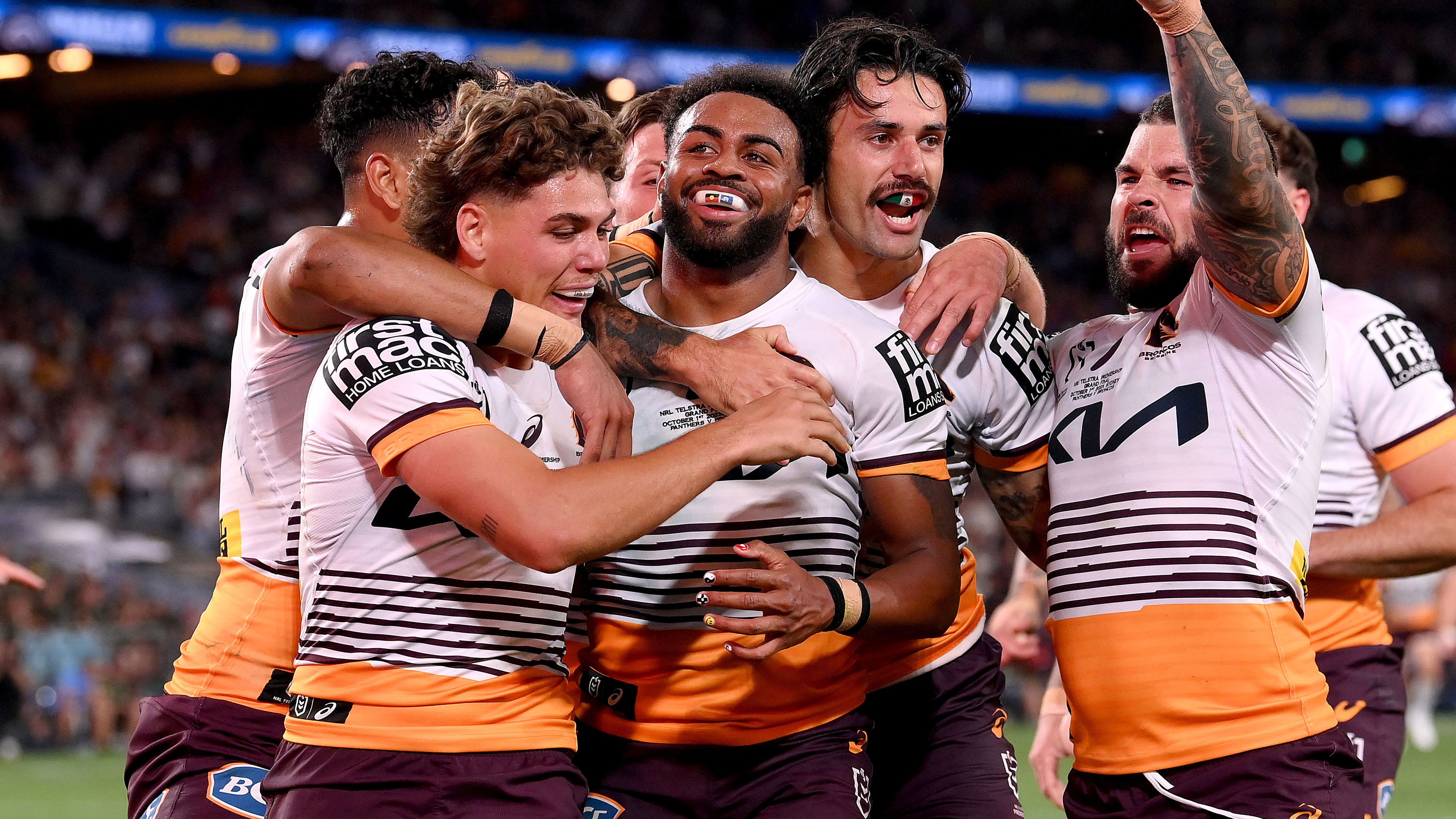 Ezra Mam of the Broncos is congratulated by teammates after scoring a try during the 2023 NRL grand final against the Panthers.