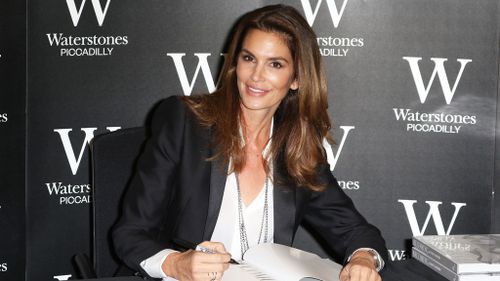 Crawford signing her new book "Becoming Cindy Crawford." (AAP)