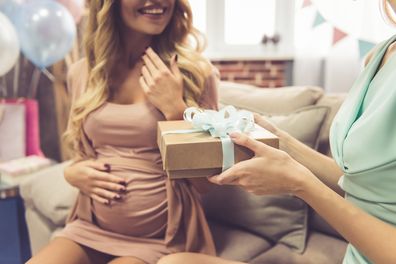 Beautiful pregnant woman and her friend are celebrating baby shower