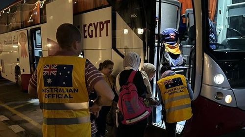 Australians board a bus after crossing from Gaza to Egypt