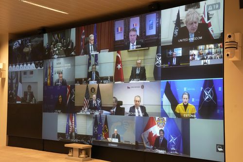 A screen shows leader during a video-conference of NATO members at the French Army headquarters, Friday, Feb. 25, 2022 in Paris.