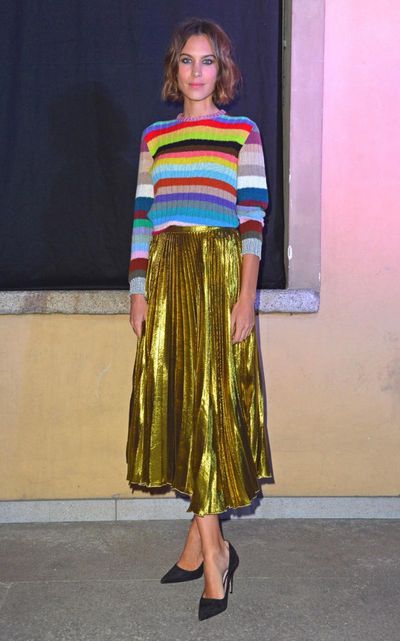 Alexa Chung uses her gamine sensibilities to combine a rainbow knit sweater
with Michele’s gold lamé skirt for surprisingly low-key results.