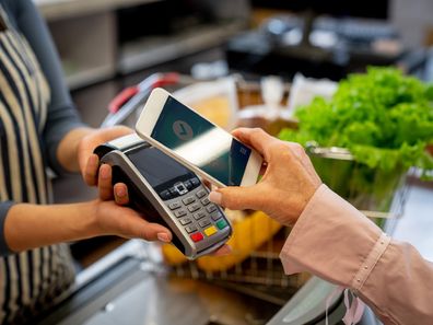 Shopper paying for groceries