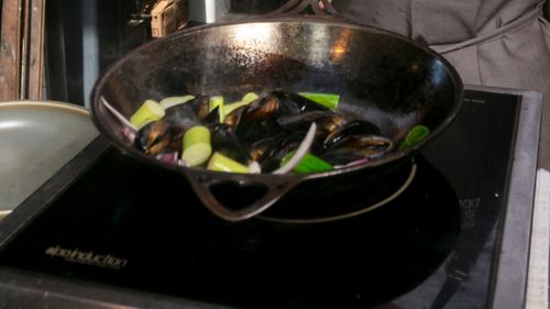 An induction cooktop with a pan on it