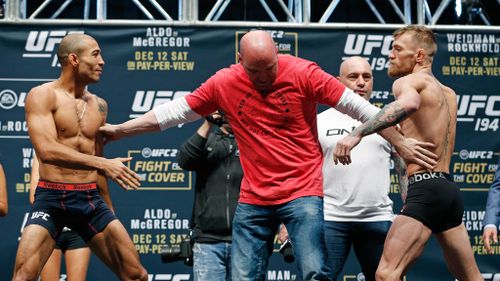 UFC president Dana White stands between Conor McGregor (right) and Jose Aldo (left) during the weigh-in for UFC 194 on Friday. (AAP)