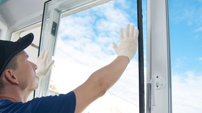 Man installing a double-glazed window