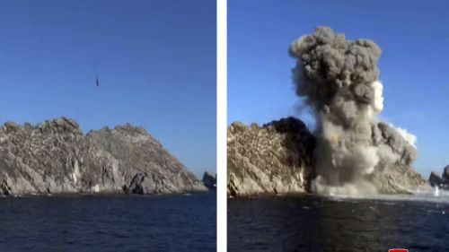 This combination of two photos provided on Jan. 15, 2022, by the North Korean government shows a landscape with cliffs and water exploding in a cloud of smoke during a missile test from a train in North Pyongan Province, North Korea.