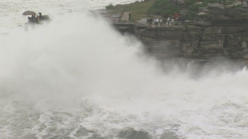 Powerful surf threatens to soak clifftop walkers on the Bondi-to-Bronte trail.