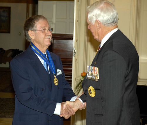 Reg Grundy receives the Order of Australia Companion in the General Division from Governor-General Major General Michael Jeffery pose at Government House, Canberra in 2008 (AAP)